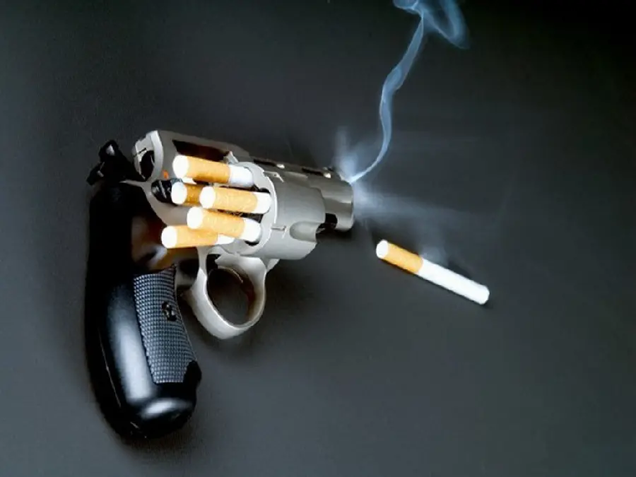 Photo of a gun and smoking bullets