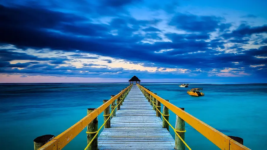 A very beautiful wooden yellow bridge image over the incredibly blue ocean in HD quality
