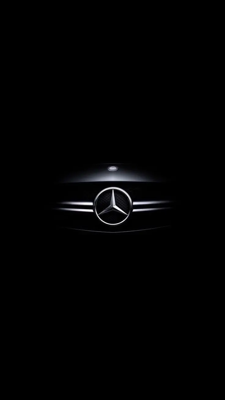 A picture of a shiny and attractive Benz logo in the dark