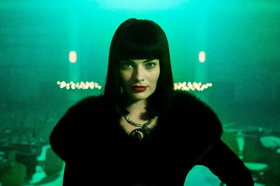 Photo of Margot Robbie with black hair and a completely black and dark team