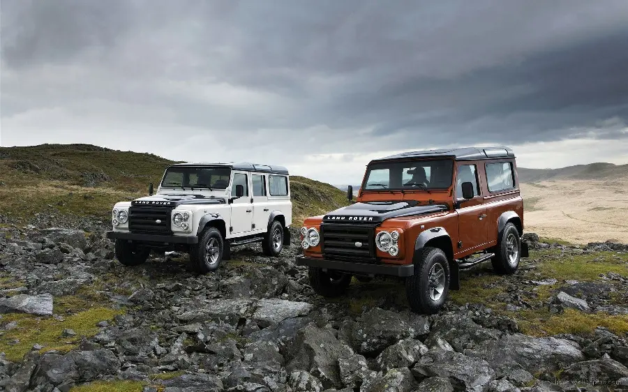 Photo of Land Rover Defenders in Red and White Sports in the Mountains
