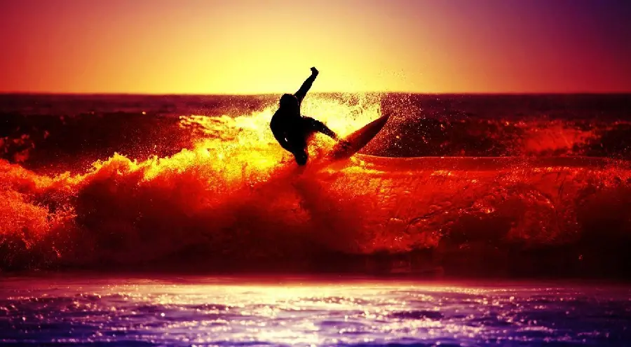 A stunningly beautiful picture of surfing at sunset