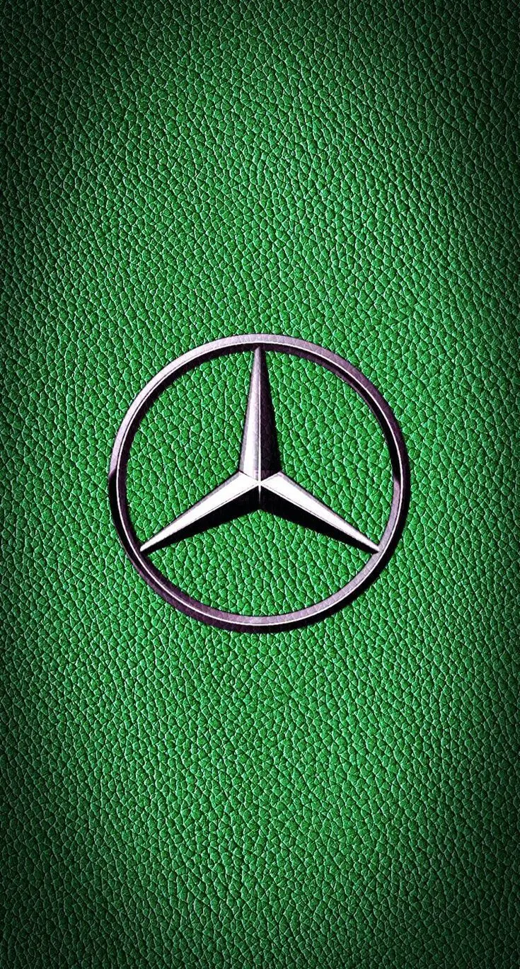 Beautiful photo of silver Mercedes-Benz logo on green background