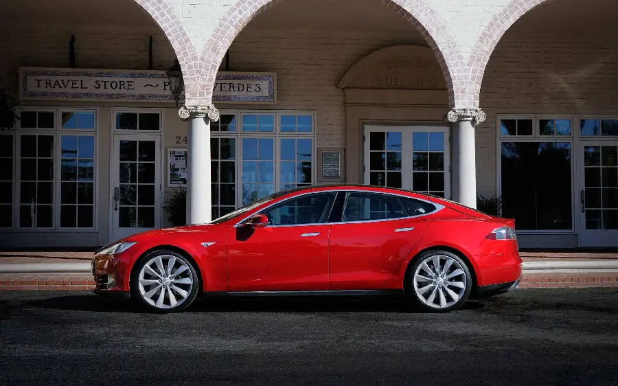 Photo of a red Tesla on the driver's side