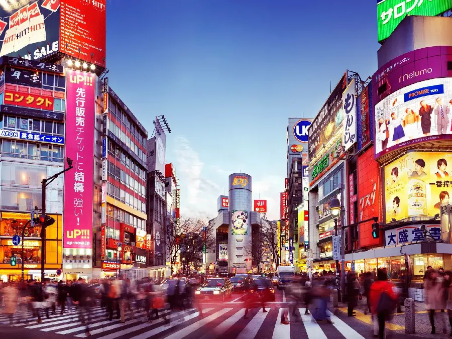 A busy Tokyo intersection with billboards in the background