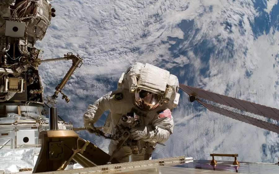 Real photo of NASA astronaut in space repairing probe
