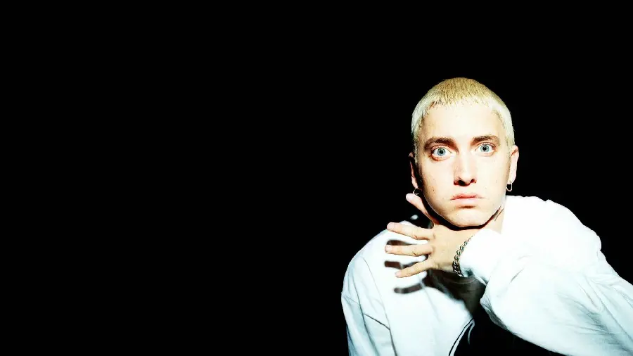 Picture of Eminem with green eyes and blonde hair with a black background