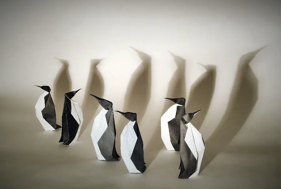 Background photo of paper penguins next to each other