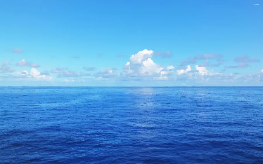 Download stylish blue ocean wallpaper under a cloudy and colorful sky for Windows 11