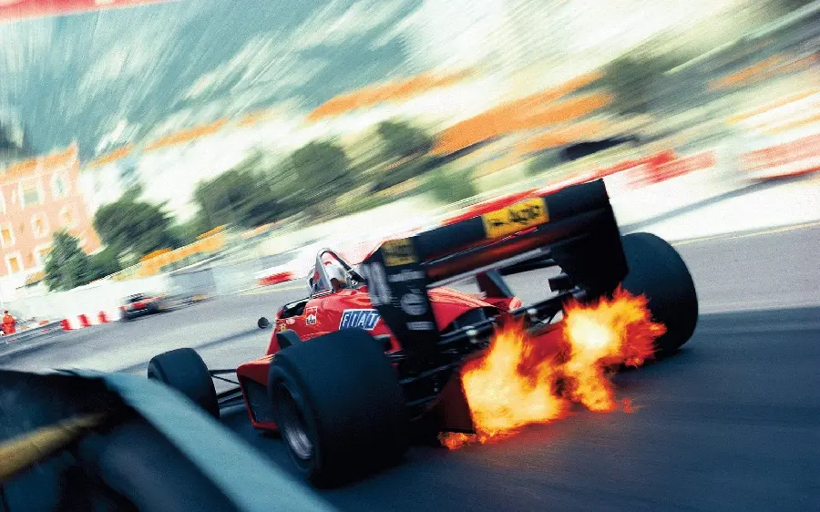 Download an attractive and exciting photo of the high speed of the Ferrari F1 and its exhaust fire in the Ferrari Formula One races
