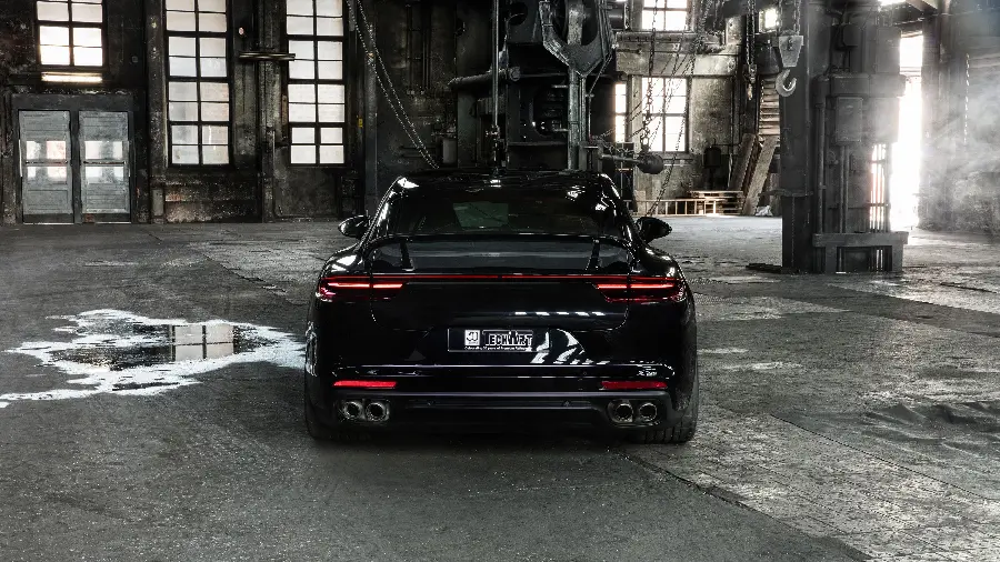 Black Porsche Panamera car background from the back with four sports exhausts