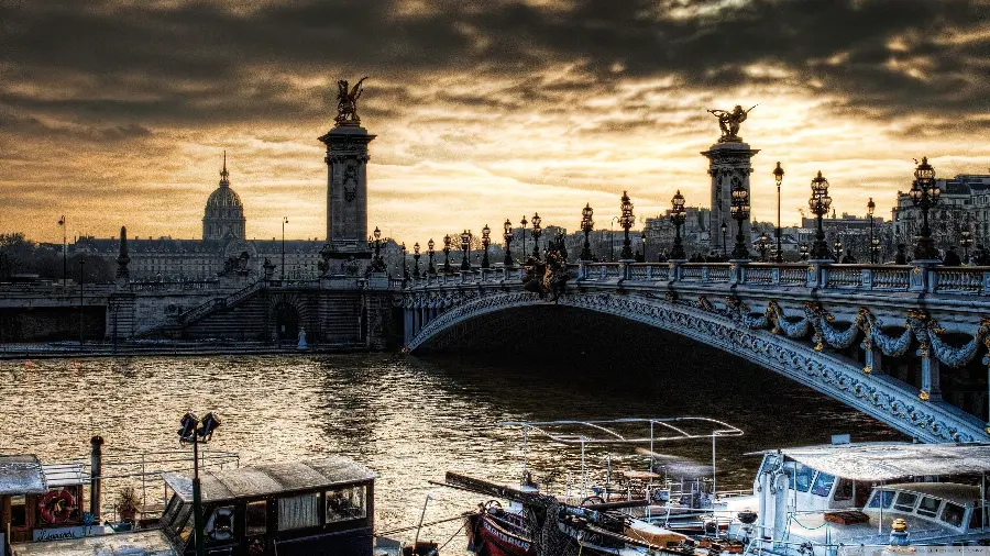 Photo of the flowing Seine River in Paris and the famous Alexander III Bridge in HD quality