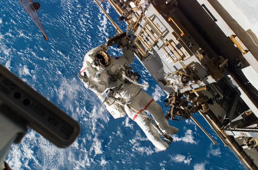 Photo of NASA astronaut repairing spaceship and probe