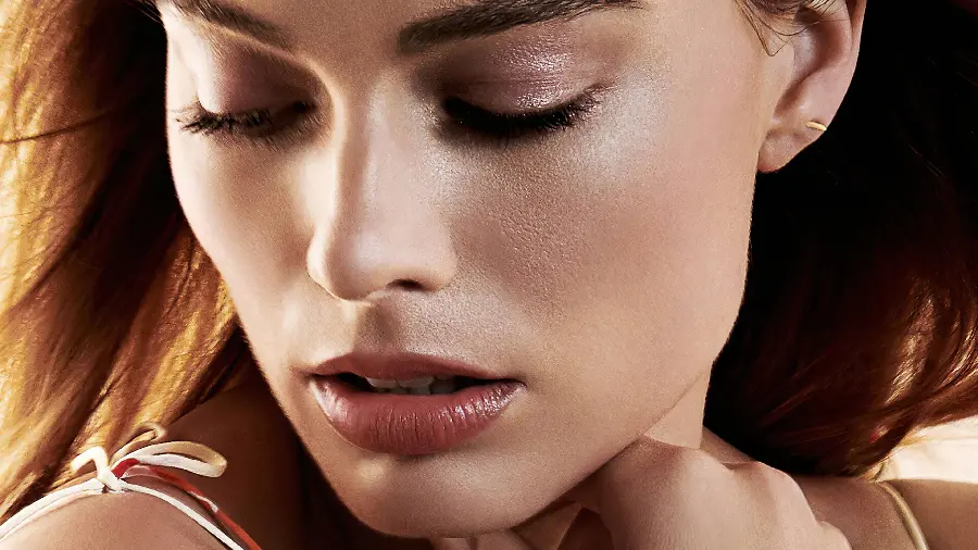 Close-up photo of Margot Robbie with makeup and makeup