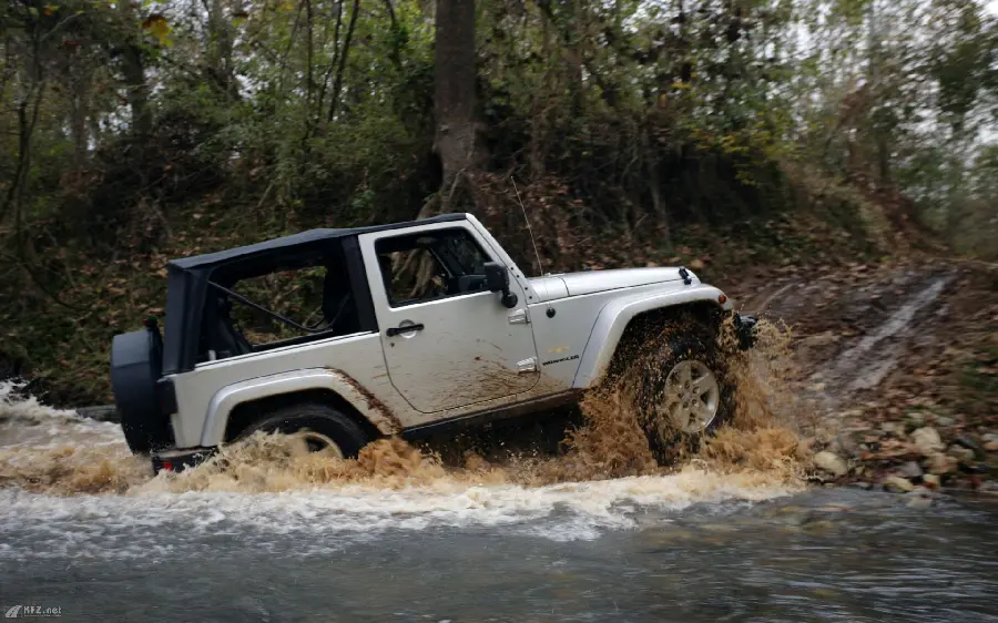Interesting image of a powerful white jeep leaving the river