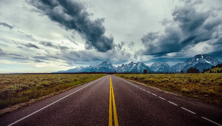 Unique photo of beautiful distant road and mountains surrounded by fog