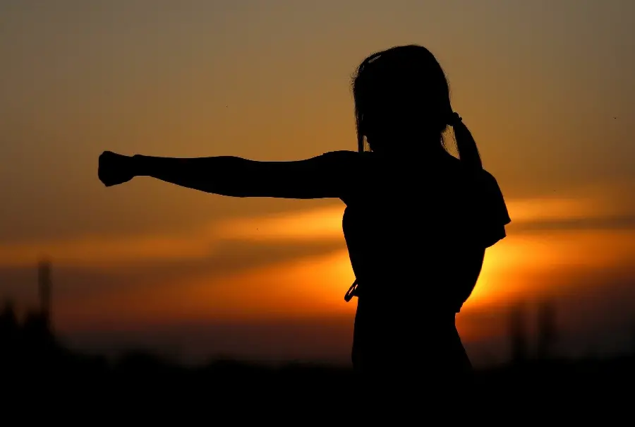 Japanese karate girl practicing photo alone in the dark for Windows 11 wallpaper
