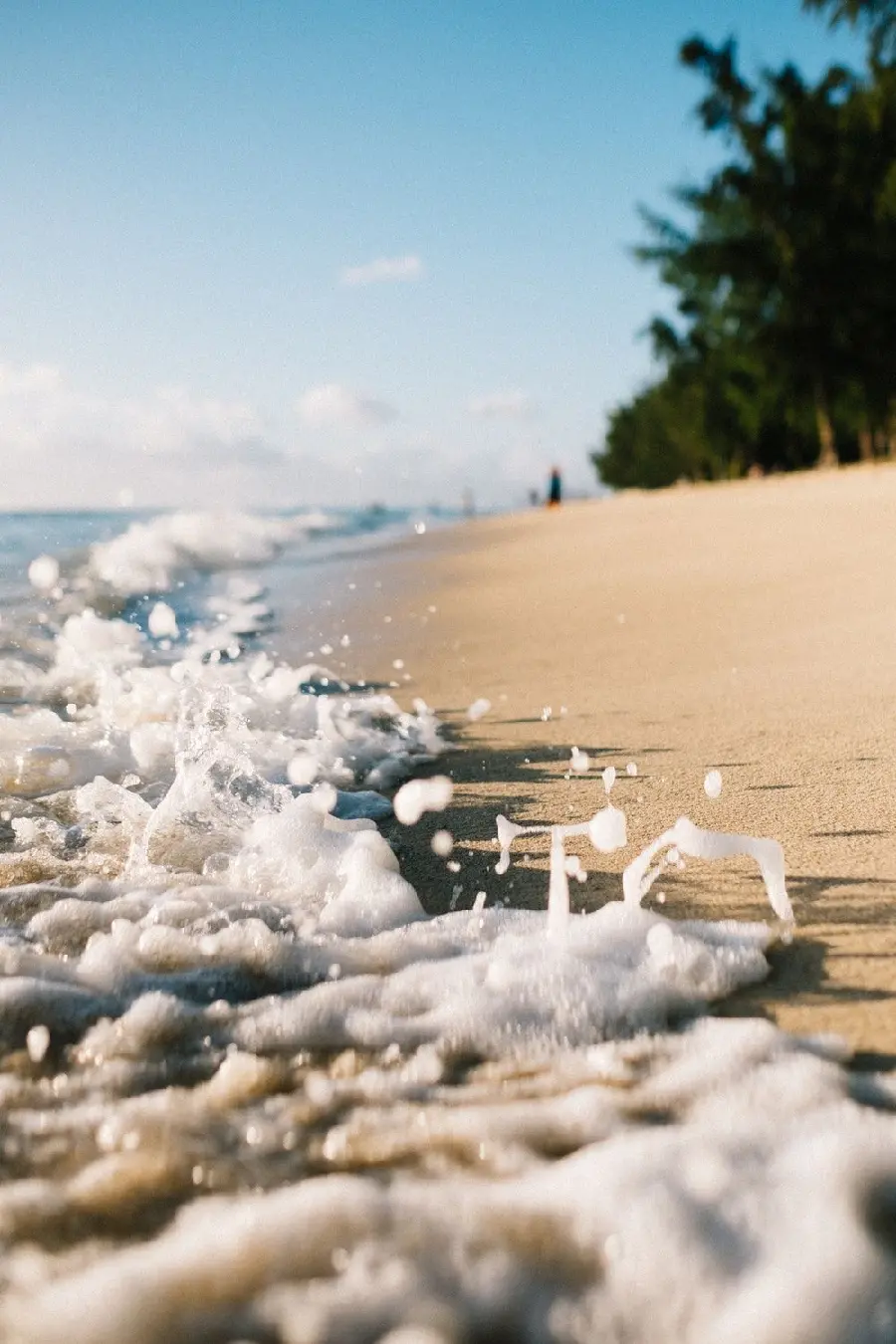 Download a photo with a wonderful angle of the ocean waves on the sandy beach for your desktop