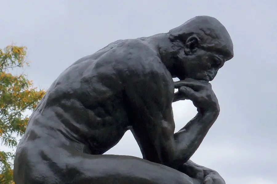 Photo of a statue of a man thinking and pondering