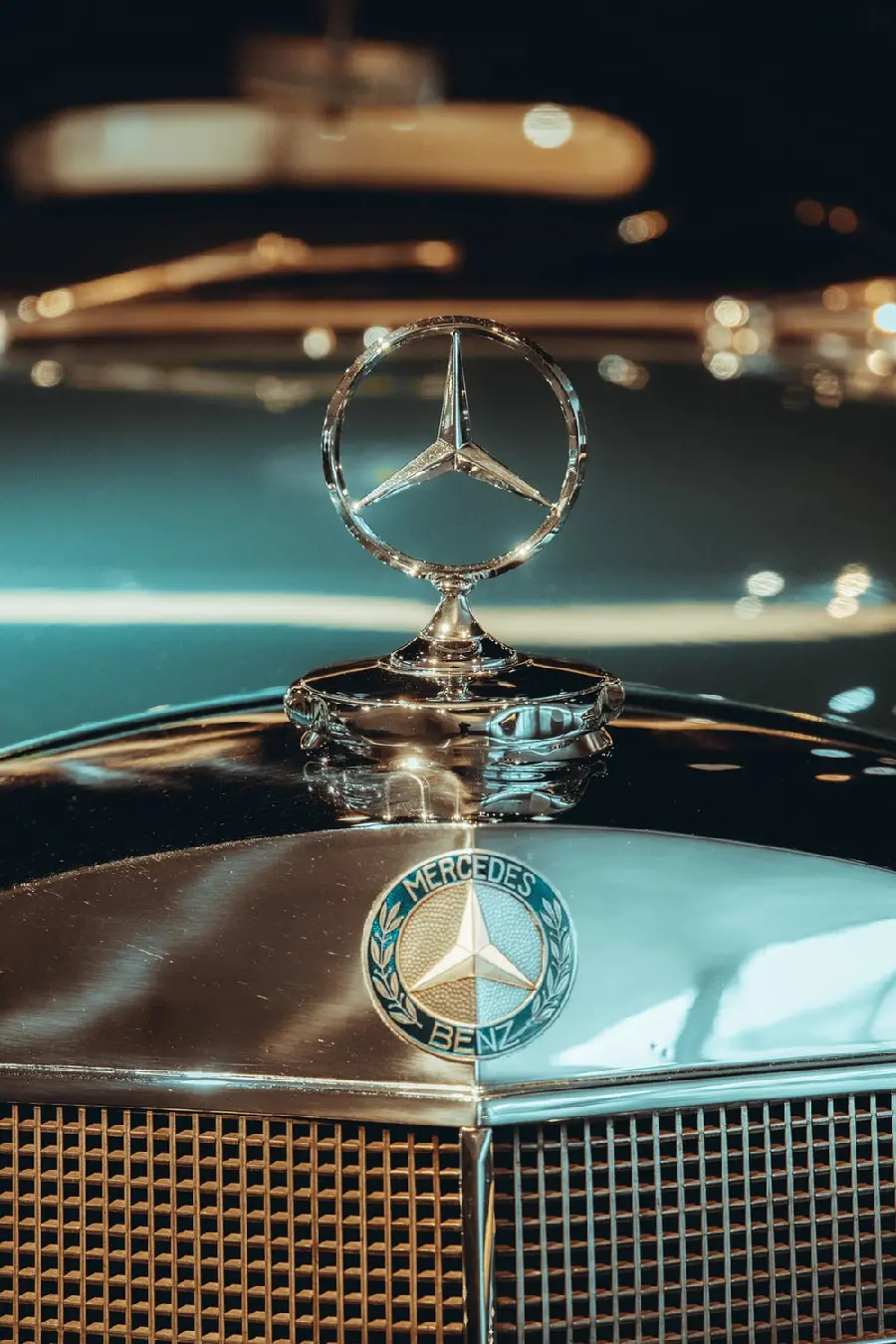 Good quality profile photo of Mercedes-Benz logo on its blue hood