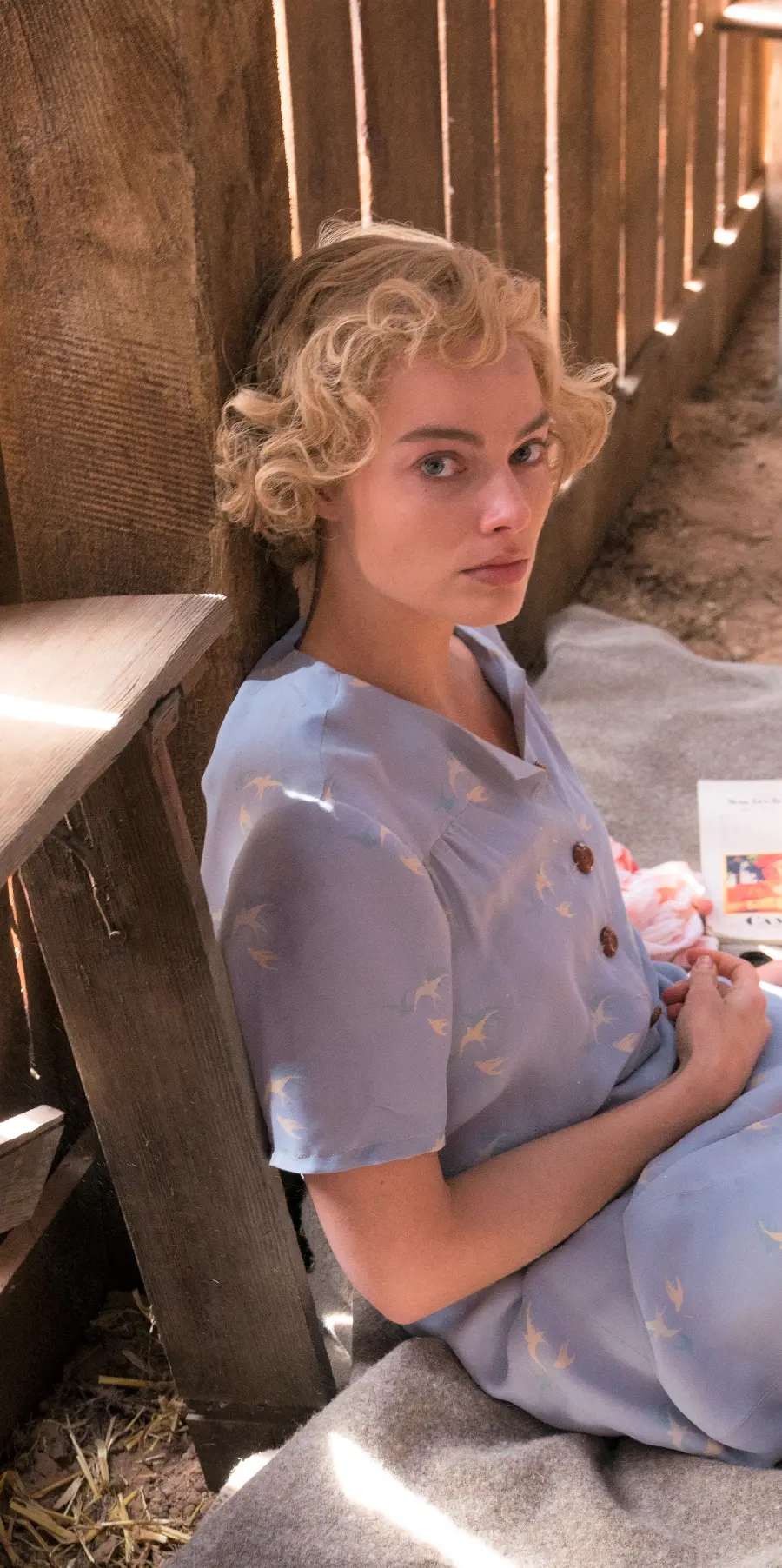 Photo of Margot Robbie with short curly yellow hair