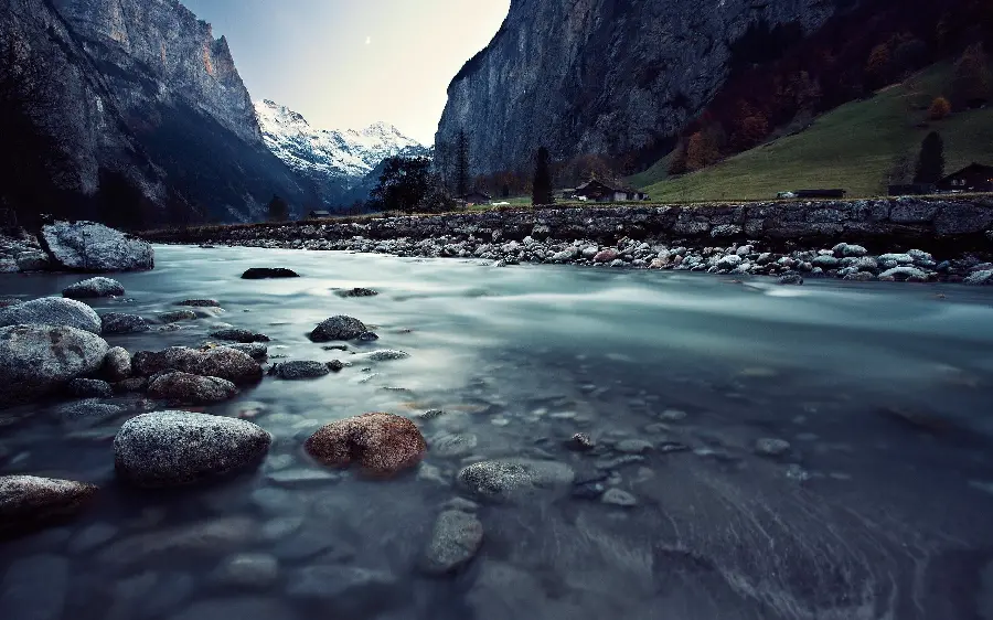 Background image of a flowing river with pristine mountain nature in winter
