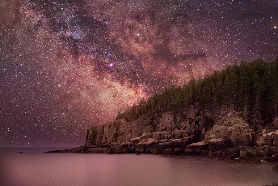 Beautiful background photo of Acadia National Park with a starry night and galaxy