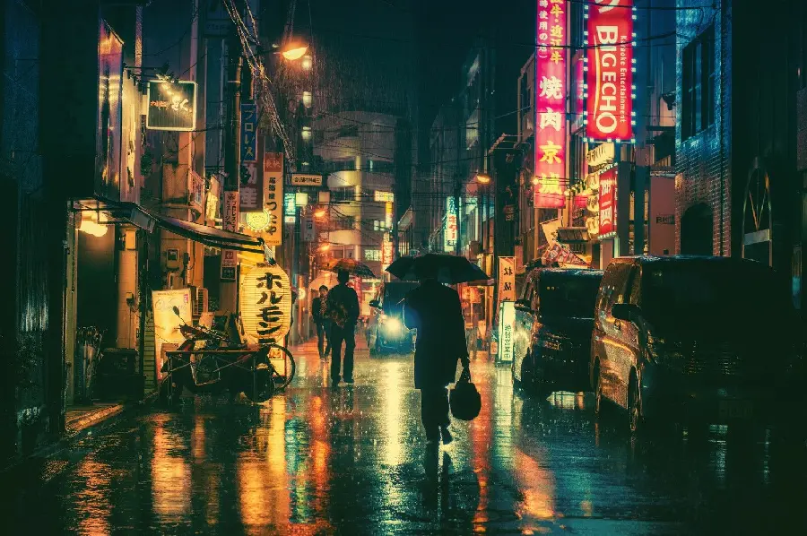 Beautiful image of Tokyo city and narrow and crowded street with pedestrians and pouring rain