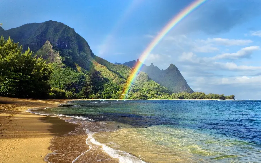 Download a cool wallpaper of the blue ocean beach with beautiful nature and a wonderful rainbow in the sky in original quality