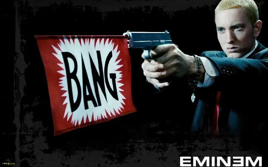 Photo of Eminem holding a gun with a black background for background