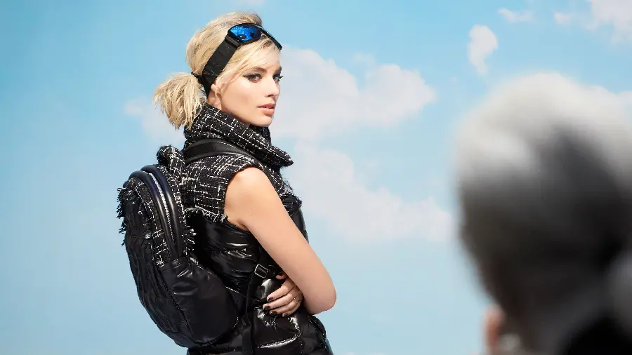 Margot Robbie background with tied blonde hair and a mask