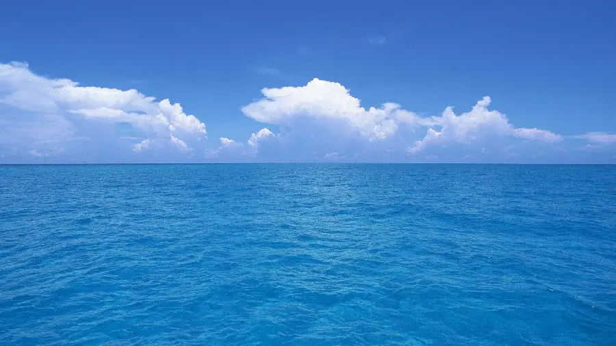 A spectacular image of blue ocean waves under a magnificent day sky for laptop and computer backgrounds