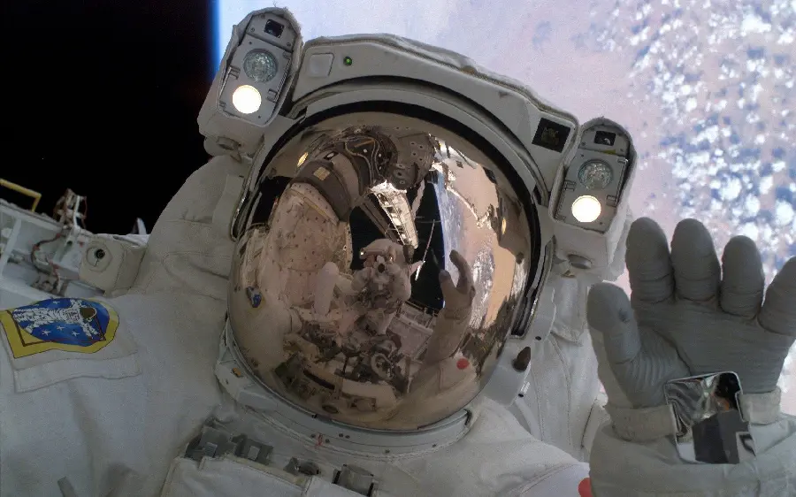 Photo of NASA astronaut saluting in the Earth's atmosphere