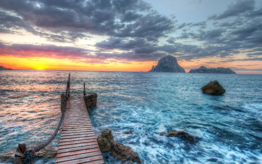 A very beautiful image of a wooden bridge on the ocean waves in the sparkling sunlight in Full HD quality