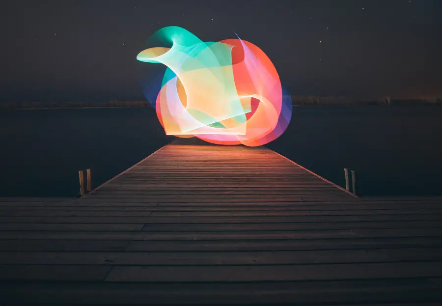 A photo for a laptop background of colorful circles on a wooden surface