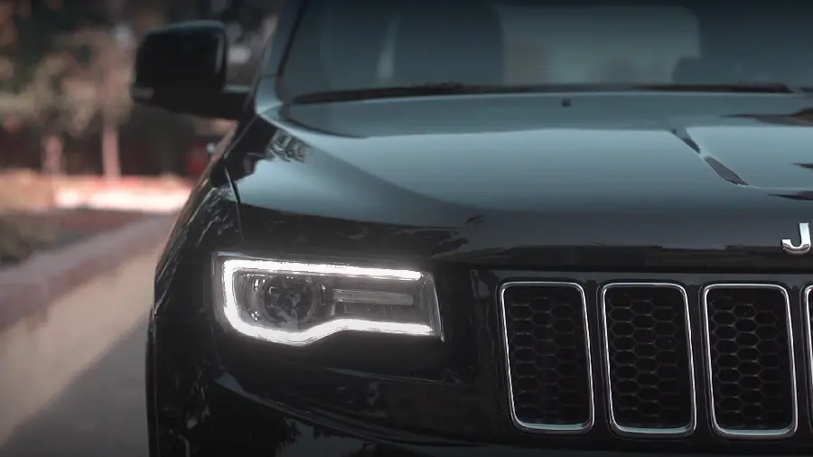 Photo of the new Jeep car from the front with bright lights, attractive and cool