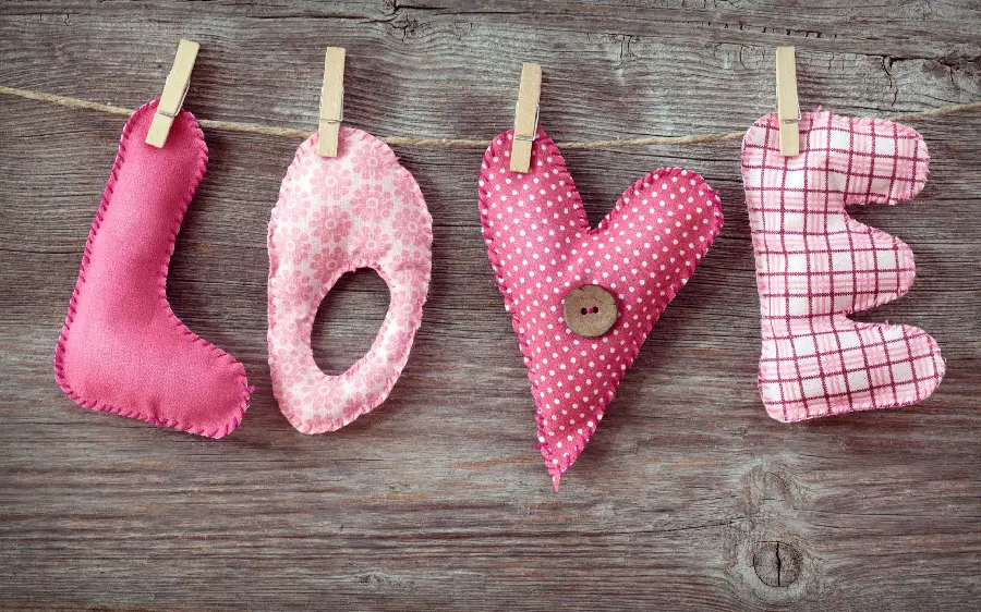 Wallpaper of the inscription Love with beautiful colors for Valentine's Day