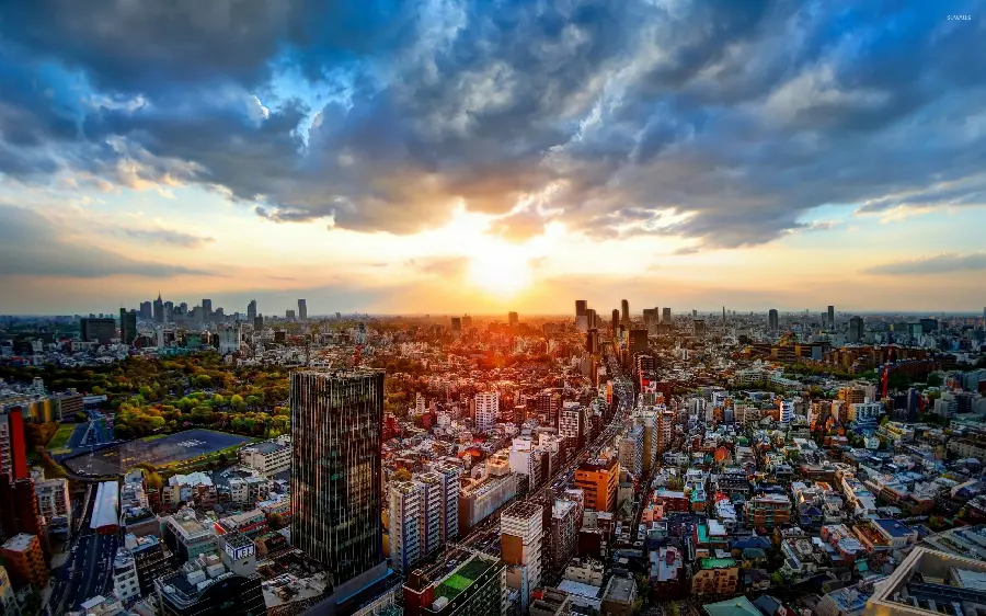 A photo of a Tokyo sunset with a cloudy sky above and a busy city