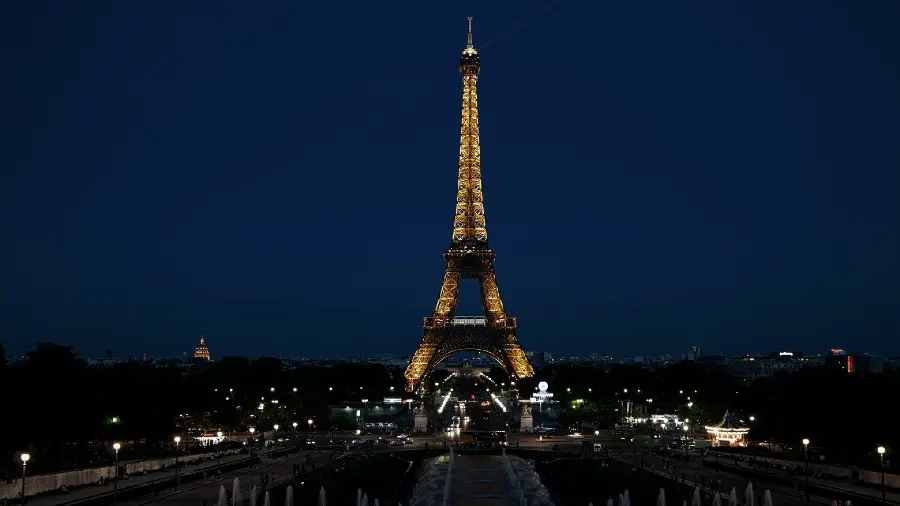 The most beautiful photo of the Eiffel Tower illuminated at night with a blue sky for a profile