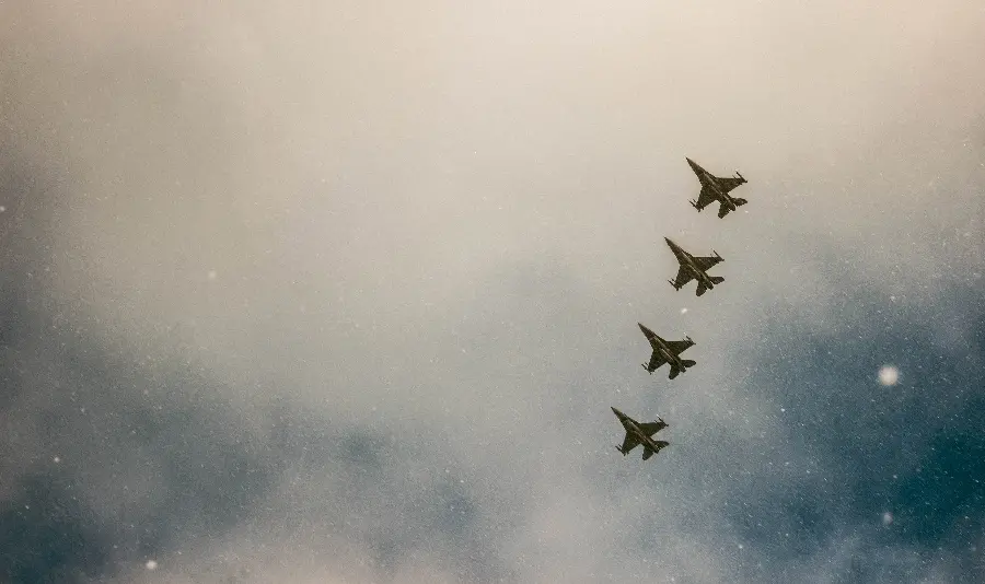 Free download of Windows wallpaper of highly detailed fighter planes flying in a cloudy sky in high quality