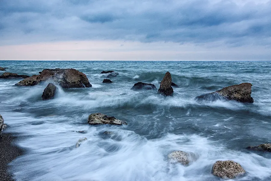 Soothing background of ocean waves hitting rocks