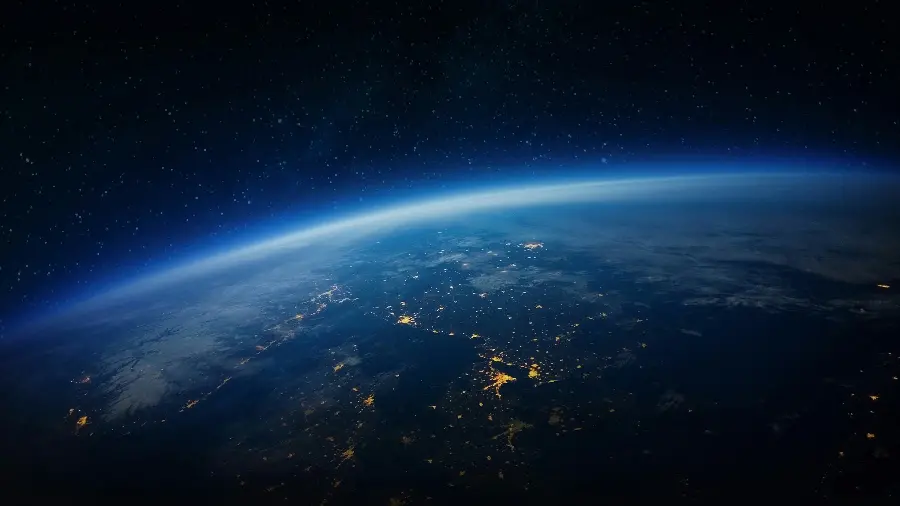 Free download of the image of the Earth at night with a blue halo around it, suitable for desktop