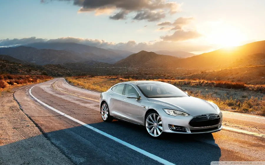Photo of a beautiful sunset with an attractive Tesla
