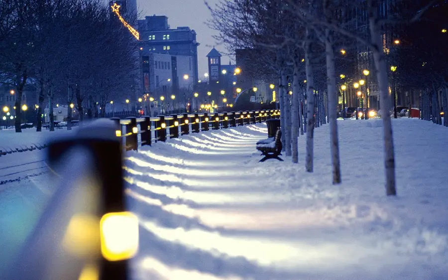 Photo of a city street with a snow-covered walkway in a winter night for a boy's profile