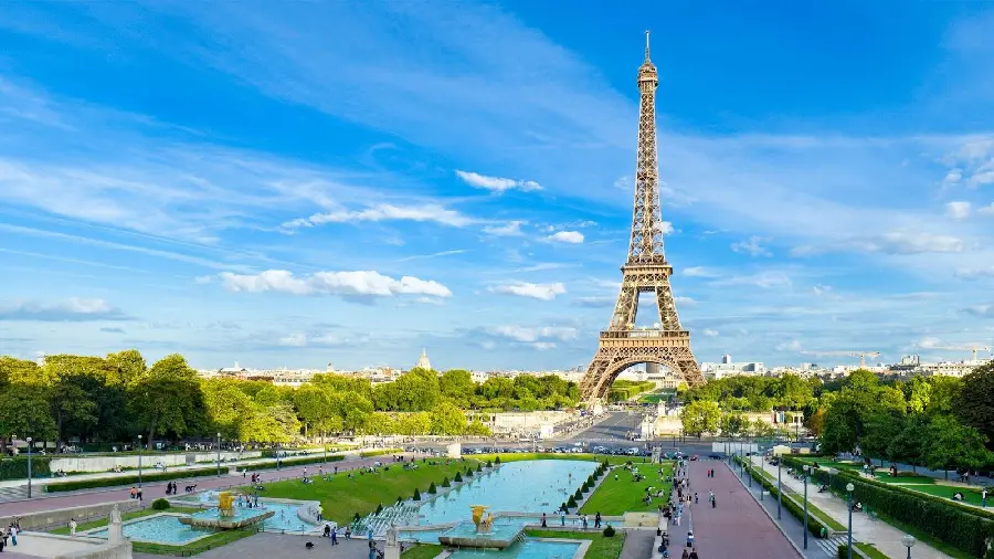 Photo of the Eiffel Tower on a spring morning in Paris, France and a cloudy blue sky