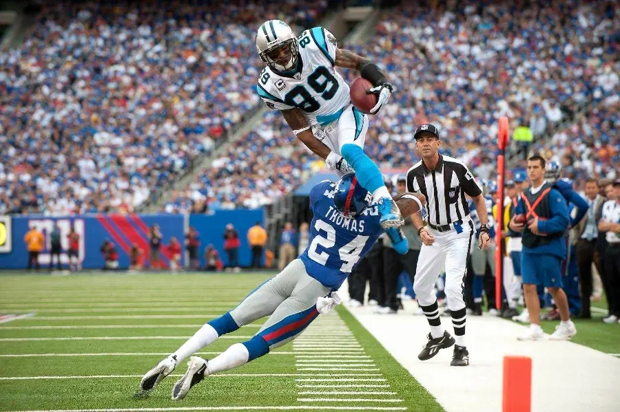 Background photo of two American football players fighting and confronting each other