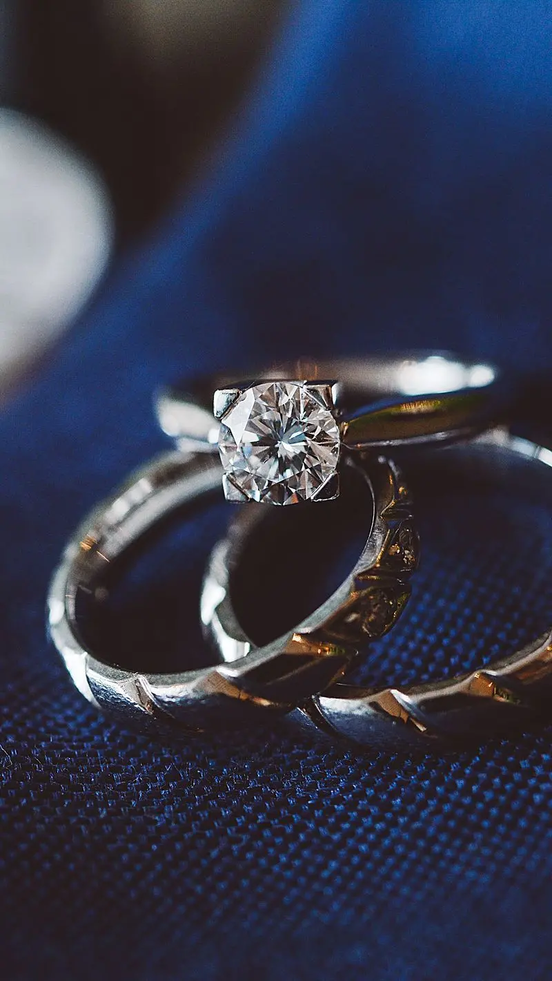 Download Poster of 3 Rings One Sparkling Diamond on a Blue Background