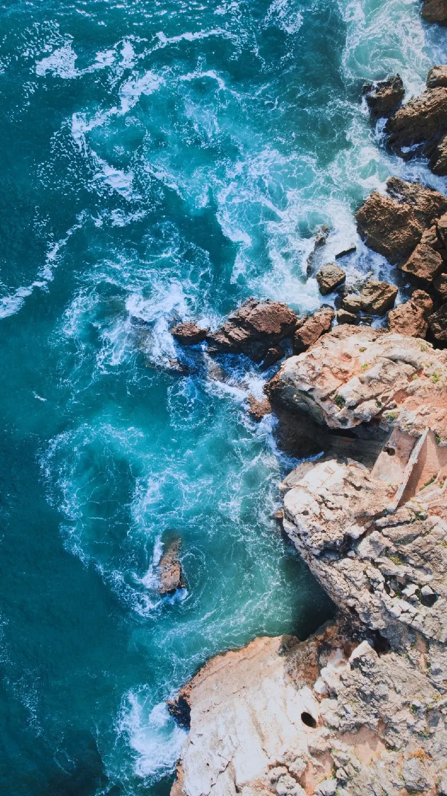 Colorful collage stock photo of ocean with beautiful water and rugged mountains in HD quality