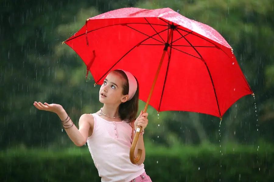 Beautiful girl in pink dress with red umbrella in real rain HD quality