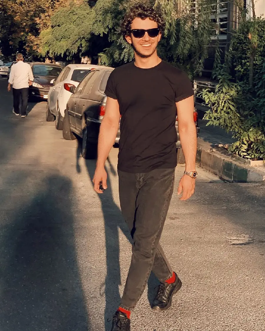Ali Shadman attractive in a sporty and black outfit in the sun, suitable for wallpaper